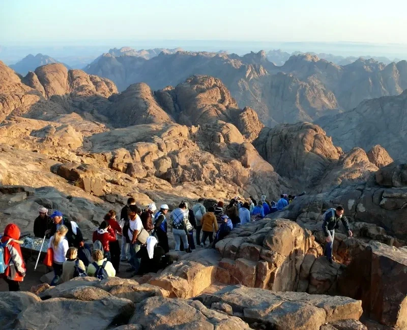 Hikers on the trail to Mount Sinai under starry skies.