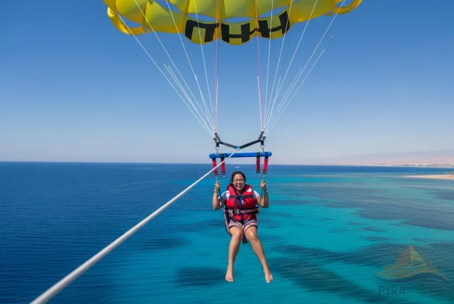 Happy person parasailing in Sharm El Sheikh with secure, modern equipment, showing a safe and joyful Red Sea adventure.