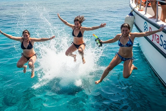 xcited tourists jumping into the Red Sea from a boat for a snorkeling adventure.