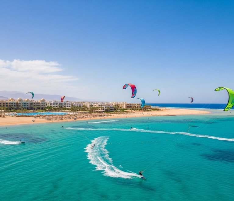 Aerial view of Nabq Bay, Sharm El Sheikh, showcasing vibrant kitesurfing and windsurfing amidst luxury resorts and clear Red Sea waters, the best kitesurfing spot Nabq Bay.